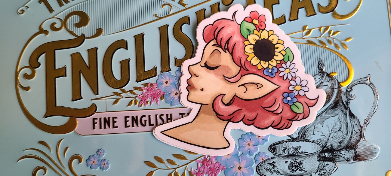 A vinyl sticker of a pink haired, elf earred girl wearing a flower crown.