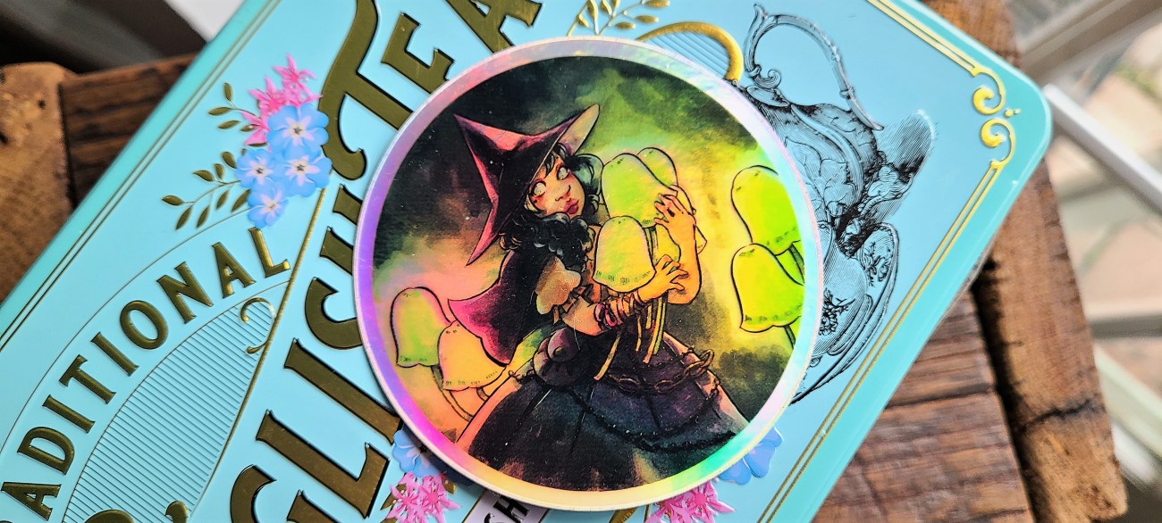 A tiny Lilliputian witch collecting glowing mushrooms in a dark cave makes for an intriguing holographic sticker.