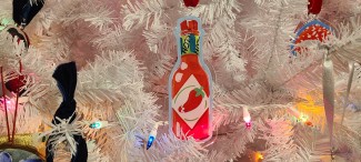 Hot sasuce acrylic ornament on a white Christmas tree